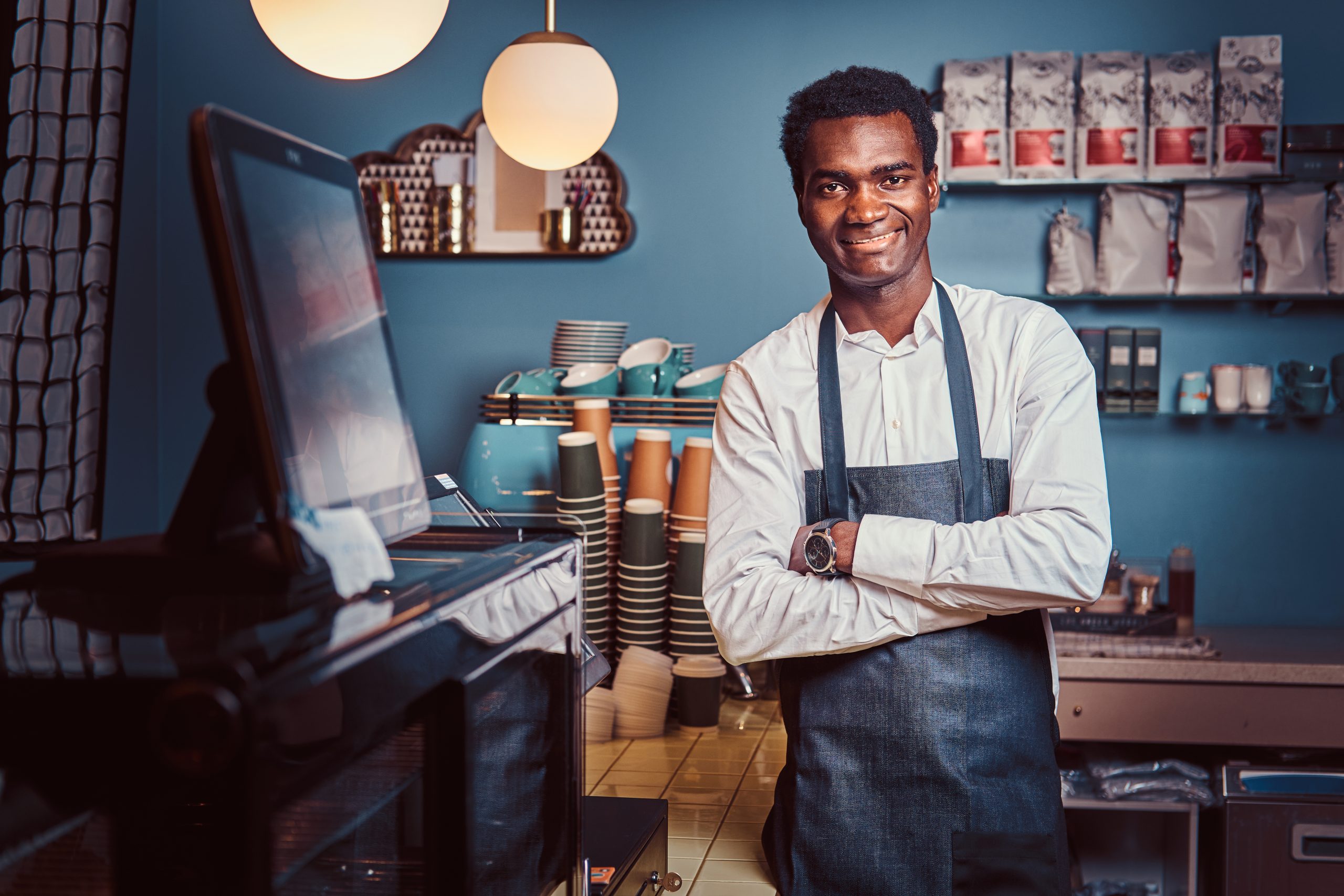 handsome african barista at coffee shop.